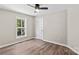 Bedroom with hardwood floors, a ceiling fan, recessed lights, and a large window at 630 W Bell St, Statesville, NC 28677