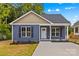 Charming blue home featuring a well-manicured lawn and dark shutters at 630 W Bell St, Statesville, NC 28677