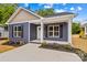 Charming blue home featuring a well-manicured lawn and dark shutters at 630 W Bell St, Statesville, NC 28677