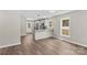 Kitchen featuring a breakfast bar, stainless appliances, and hardwood flooring at 630 W Bell St, Statesville, NC 28677