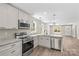 Modern kitchen features stainless steel appliances, white cabinets, and an island with bar seating at 630 W Bell St, Statesville, NC 28677