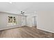 Bright living room with wood floors, neutral walls, and modern ceiling fan at 630 W Bell St, Statesville, NC 28677