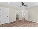 Spacious main bedroom with hardwood floors, ceiling fan, and ensuite bathroom at 630 W Bell St, Statesville, NC 28677