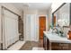 Bathroom features modern vanity, mirror, neutral tile and a shower with curtain at 6362 Sherrills Ford Rd, Catawba, NC 28609