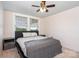 A cozy bedroom with a ceiling fan, two windows, and neutral walls at 6362 Sherrills Ford Rd, Catawba, NC 28609