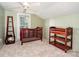 A bedroom with a dark wood crib and ceiling fan at 6362 Sherrills Ford Rd, Catawba, NC 28609