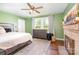 A bedroom featuring hardwood floors, a fireplace, and multiple windows for natural light at 6362 Sherrills Ford Rd, Catawba, NC 28609