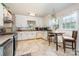 Bright kitchen with white cabinets, stainless steel appliances, and a cozy breakfast nook at 6362 Sherrills Ford Rd, Catawba, NC 28609