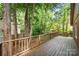 Back deck with wood railing surrounded by mature trees at 7 Turtle Ln, Clover, SC 29710
