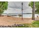 Lakefront beach with sandy shore, wooden pier, and boat dock at 7 Turtle Ln, Clover, SC 29710