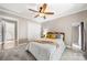 Comfortable bedroom features soft carpet, a ceiling fan, and an adjacent closet, ensuring comfort and convenience at 7 Turtle Ln, Clover, SC 29710