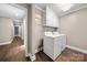 Bright laundry room with white cabinets, a hanging rack, and modern washer and dryer at 7 Turtle Ln, Clover, SC 29710