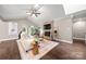Inviting living room featuring a stone fireplace, vaulted ceiling, and abundant natural light at 7 Turtle Ln, Clover, SC 29710