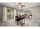 Bright home office with a desk, chair, sliding glass doors to the deck, and an opening into the living room at 7 Turtle Ln, Clover, SC 29710