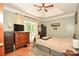 Inviting bedroom featuring hardwood floors, a tray ceiling, and a large window overlooking the wooded backyard at 7328 S Providence Rd, Waxhaw, NC 28173