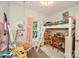 Bright bedroom featuring loft bed, desk, a string of lights, and a large window at 7328 S Providence Rd, Waxhaw, NC 28173