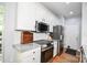 Bright kitchen featuring stainless steel appliances, granite countertops, white cabinets, and tile backsplash at 7328 S Providence Rd, Waxhaw, NC 28173