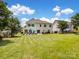 Large backyard with a spacious patio area, perfect for outdoor gatherings and relaxation at 7627 Woodcrest Dr, Stanley, NC 28164
