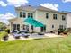 Backyard patio with lounge chairs, umbrella, and grill, perfect for outdoor entertaining at 7627 Woodcrest Dr, Stanley, NC 28164