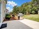 Outdoor patio area with a stainless steel grill and a view of the lush backyard at 7627 Woodcrest Dr, Stanley, NC 28164