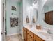 Bathroom featuring double sinks, a vanity, and stylish tile flooring creating a modern and functional space at 7627 Woodcrest Dr, Stanley, NC 28164