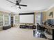 This spacious bonus room features a ceiling fan and a home theater setup with a large screen at 7627 Woodcrest Dr, Stanley, NC 28164