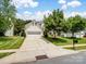 Inviting two-story home with a driveway, well-kept lawn, and lush landscaping at 7627 Woodcrest Dr, Stanley, NC 28164