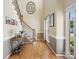 Hallway with hardwood floors and staircase at 7627 Woodcrest Dr, Stanley, NC 28164