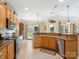 Open kitchen with stainless steel appliances, granite countertops, and views to the backyard at 7627 Woodcrest Dr, Stanley, NC 28164