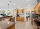Bright kitchen with granite countertops, stainless steel appliances and breakfast nook at 7627 Woodcrest Dr, Stanley, NC 28164