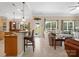 Open concept living room and kitchen showcasing an eat-in island and abundant natural light at 7627 Woodcrest Dr, Stanley, NC 28164