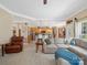 Inviting living room featuring an open layout with a view of the modern kitchen and a comfortable sectional sofa at 7627 Woodcrest Dr, Stanley, NC 28164