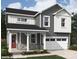 Charming two-story home featuring gray siding, stone accents, a covered porch, and an attached two-car garage at 9858 Quercus Ln, Huntersville, NC 28078