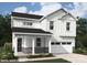 Charming two-story home with stone accents, covered entry, white siding, and attached garage at 9858 Quercus Ln, Huntersville, NC 28078