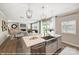 Spacious kitchen with white cabinets, a stainless steel sink, a marble countertop, and seamless views into the living area at 9858 Quercus Ln, Huntersville, NC 28078