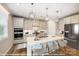 Modern kitchen features white cabinets, stainless steel appliances, a large center island, and pendant lighting at 9858 Quercus Ln, Huntersville, NC 28078
