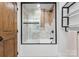 Bathroom with a tub-shower featuring decorative tile and a glass door at 120 Lakeshore Dr, Mooresville, NC 28117