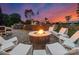Outdoor fire pit with seating under a twilight sky, creating a cozy entertainment space with green surroundings at 120 Lakeshore Dr, Mooresville, NC 28117