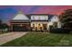 Charming two-story home featuring a covered front porch and well-manicured lawn at 120 Lakeshore Dr, Mooresville, NC 28117