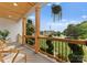 Inviting covered front porch with modern seating, hanging plants, with views of a well-manicured street at 120 Lakeshore Dr, Mooresville, NC 28117