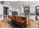 Modern kitchen with white cabinetry, a dark backsplash, a large island with bar seating, and stainless steel appliances at 120 Lakeshore Dr, Mooresville, NC 28117