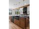 Kitchen island with wooden cabinetry, black countertops, and modern pendant lighting, featuring stainless steel appliances at 120 Lakeshore Dr, Mooresville, NC 28117