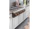 The beautifully designed kitchen boasts custom cabinets and an attractive gas stove at 120 Lakeshore Dr, Mooresville, NC 28117