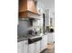 Updated kitchen with white cabinets, black countertops, and stainless steel appliances, featuring modern fixtures at 120 Lakeshore Dr, Mooresville, NC 28117