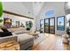 Bright and airy living room with a large sectional, hardwood floors, and views of the outdoor pool area at 120 Lakeshore Dr, Mooresville, NC 28117