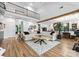 Open-concept living room featuring hardwood floors, a large sectional, and an open view to the kitchen at 120 Lakeshore Dr, Mooresville, NC 28117