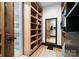 Walk-in closet with custom shelving, cabinets, and an adjoining bathroom at 120 Lakeshore Dr, Mooresville, NC 28117