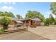 Backyard showcasing a brick home exterior, patio with swing, concrete, and gravel area at 124 Courtney Ln, Matthews, NC 28105