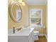 Bathroom featuring a modern vanity with white countertop and a round mirror above at 124 Courtney Ln, Matthews, NC 28105