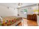 Cozy bedroom features hardwood floors, a window for natural light, and a colorful patchwork quilt at 124 Courtney Ln, Matthews, NC 28105